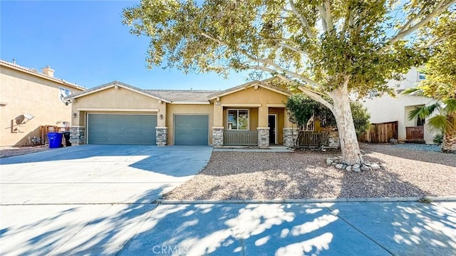 view of front of home with an attached garage, stone siding, concrete driveway, and stucco siding