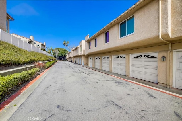 view of street featuring a residential view and curbs