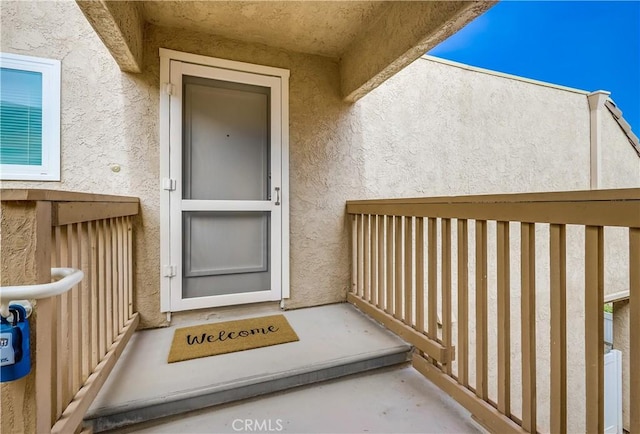 property entrance featuring stucco siding