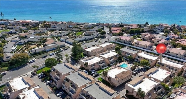 drone / aerial view with a water view and a residential view
