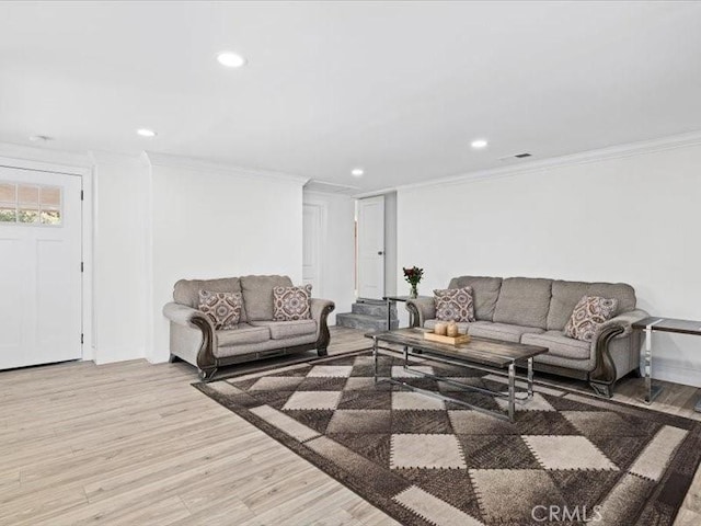 living area with light wood finished floors, crown molding, and recessed lighting