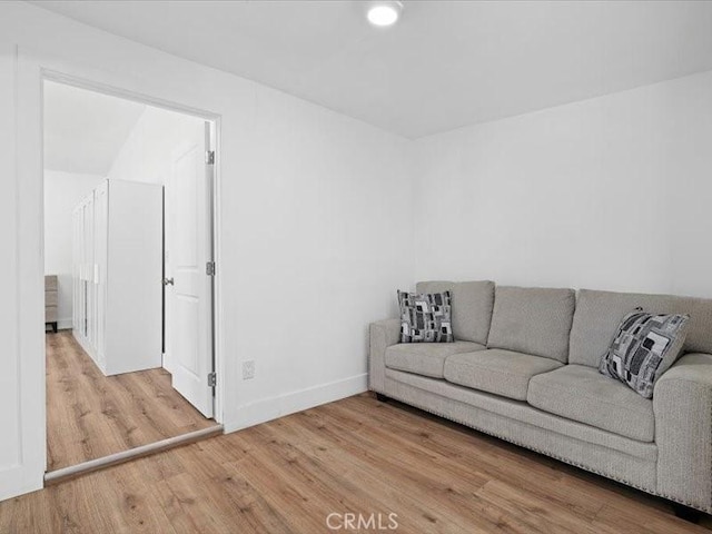 living room featuring baseboards and wood finished floors