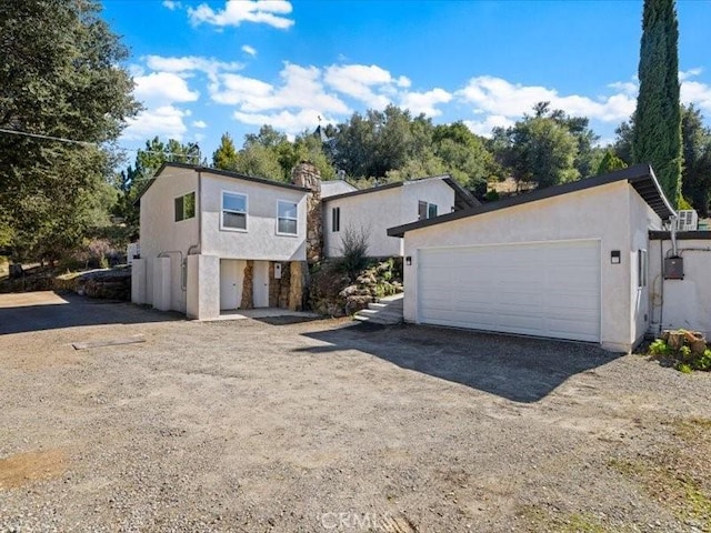 view of front facade featuring driveway and stucco siding