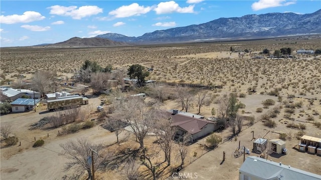 birds eye view of property with a rural view, a mountain view, and view of desert