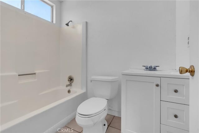 full bath with tile patterned flooring, toilet, vanity, baseboards, and shower / washtub combination