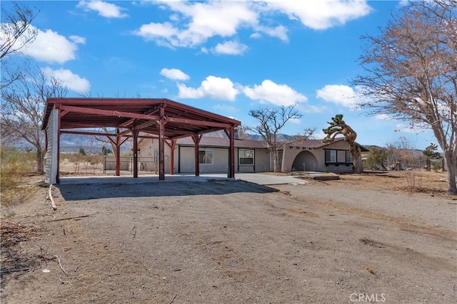 surrounding community with driveway and a carport