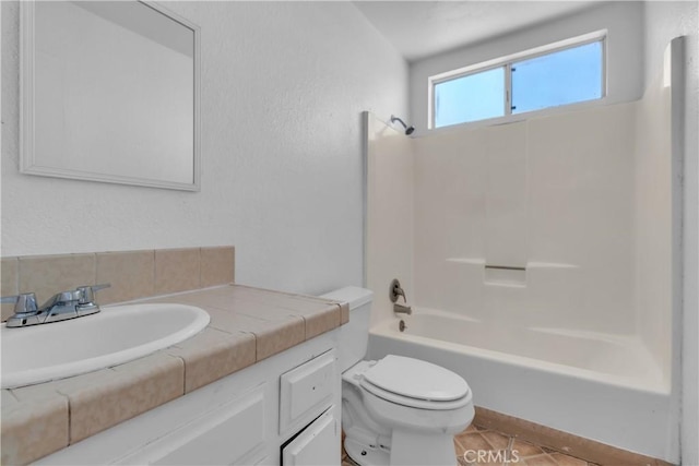 bathroom featuring  shower combination, vanity, toilet, and tile patterned floors