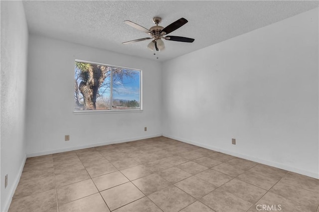 unfurnished room featuring ceiling fan, a textured ceiling, and baseboards