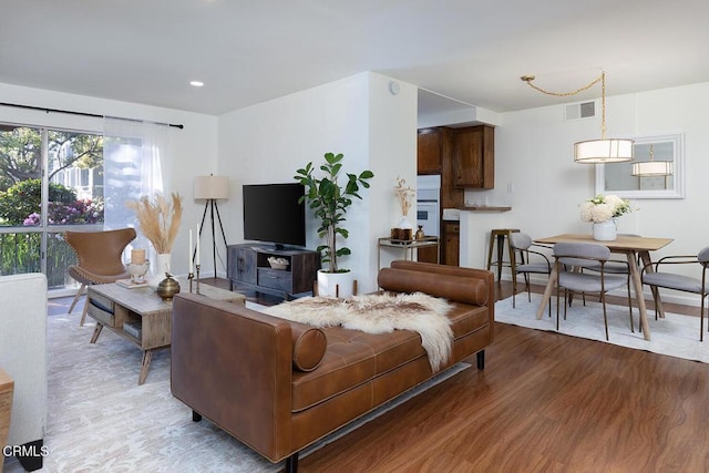 living area featuring visible vents, wood finished floors, and recessed lighting