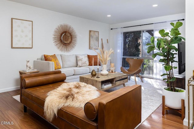 living room with baseboards, wood finished floors, and recessed lighting