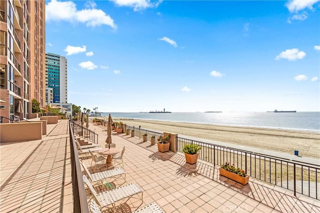 exterior space featuring a view of the beach and a water view