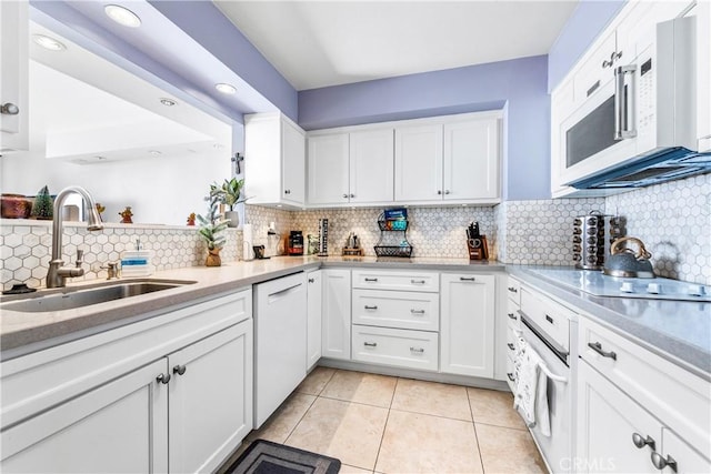 kitchen featuring light countertops, white appliances, white cabinetry, and a sink