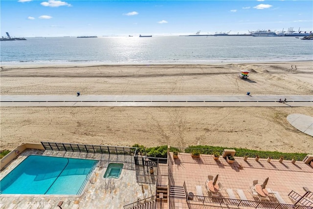 birds eye view of property featuring a water view and a view of the beach