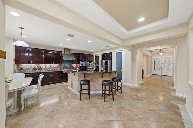 2514 Bulrush Cir, Corona, CA 92882 - kitchen featuring appliances with stainless steel finishes, ventilation hood, a kitchen breakfast bar, tasteful backsplash, and recessed lighting