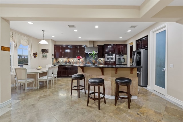 2514 Bulrush Cir, Corona, CA 92882 - kitchen with appliances with stainless steel finishes, a breakfast bar, decorative backsplash, baseboards, and recessed lighting