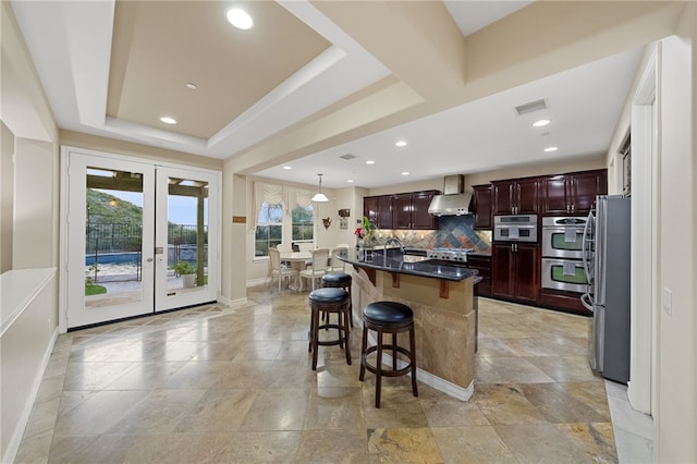 2514 Bulrush Cir, Corona, CA 92882 - kitchen featuring appliances with stainless steel finishes, french doors, decorative backsplash, baseboards, and a kitchen bar