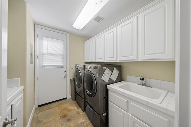 2514 Bulrush Cir, Corona, CA 92882 - laundry room featuring cabinet space, washer and clothes dryer, baseboards, and light stone finish flooring