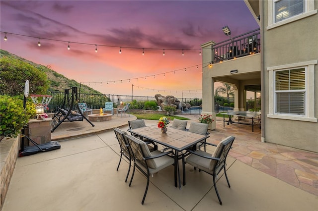 2514 Bulrush Cir, Corona, CA 92882 - view of patio with an outdoor fire pit, outdoor dining area, a balcony, and fence