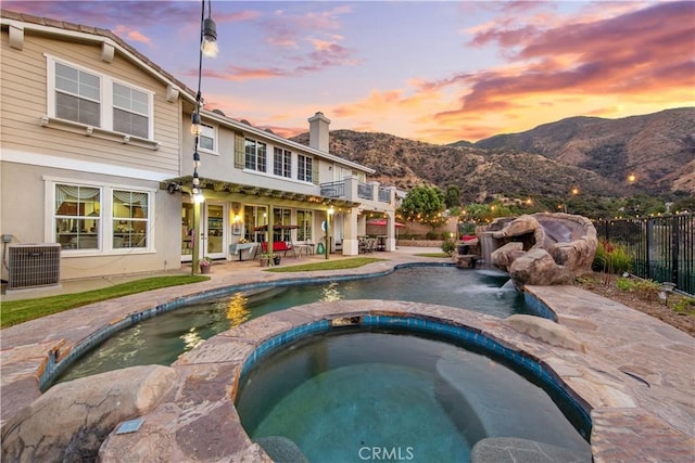 2514 Bulrush Cir, Corona, CA 92882 - view of swimming pool with a mountain view, fence, a patio area, a pool with connected hot tub, and cooling unit