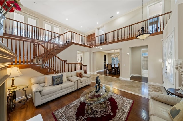 2514 Bulrush Cir, Corona, CA 92882 - living area with stairway, a chandelier, baseboards, wood-type flooring, and a towering ceiling