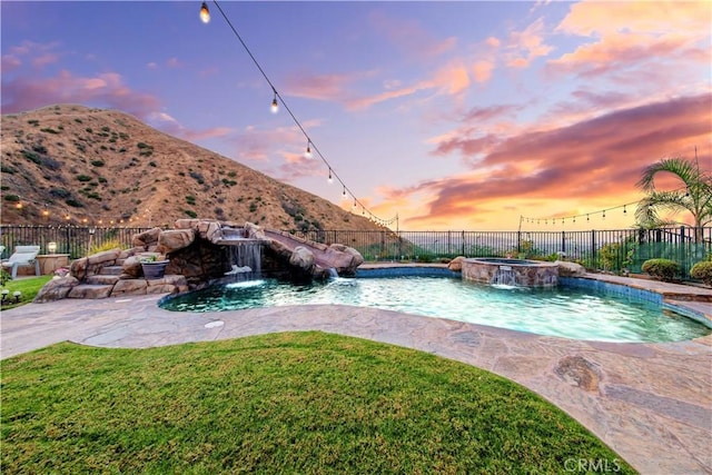 2514 Bulrush Cir, Corona, CA 92882 - pool at dusk with a mountain view and a pool with connected hot tub