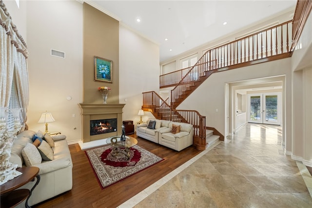 2514 Bulrush Cir, Corona, CA 92882 - living area with baseboards, stairs, a glass covered fireplace, a high ceiling, and recessed lighting