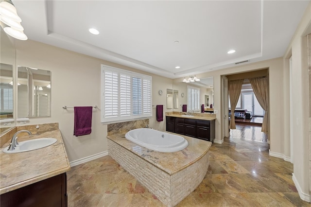 2514 Bulrush Cir, Corona, CA 92882 - full bath with a raised ceiling, baseboards, a bath, two vanities, and stone finish floors