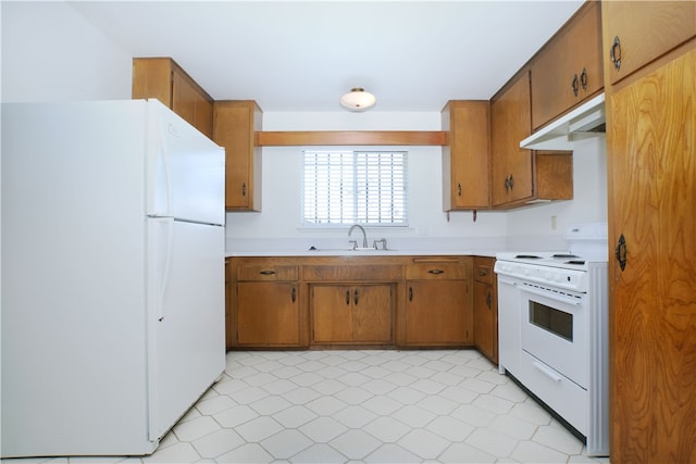 kitchen featuring light countertops, white appliances, a sink, and under cabinet range hood