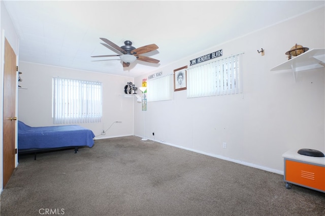 unfurnished bedroom with ceiling fan, carpet floors, and baseboards