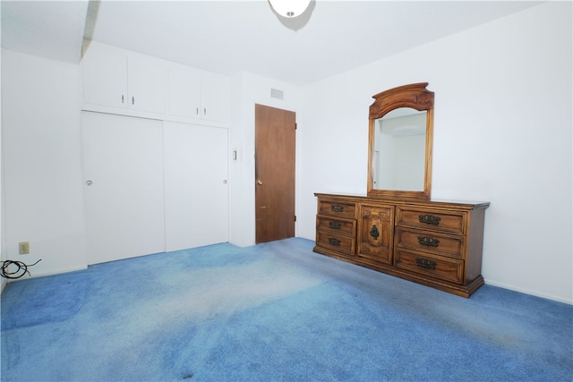 bedroom featuring a closet, carpet flooring, and visible vents