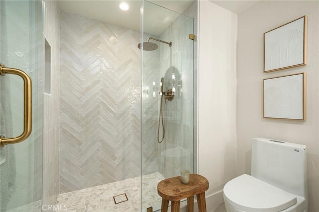 bathroom featuring a shower stall and toilet