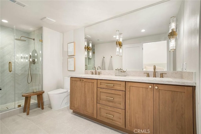 full bathroom featuring toilet, a stall shower, visible vents, and a sink