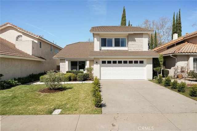 traditional home with an attached garage, concrete driveway, and a front yard