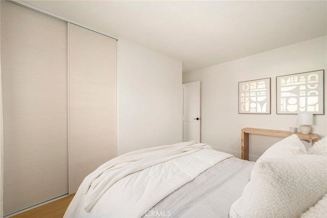 bedroom featuring a closet and wood finished floors