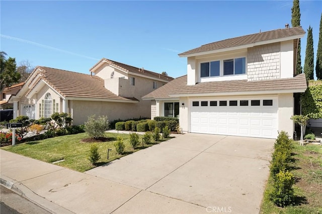 view of front of property with driveway, stucco siding, an attached garage, and a front yard