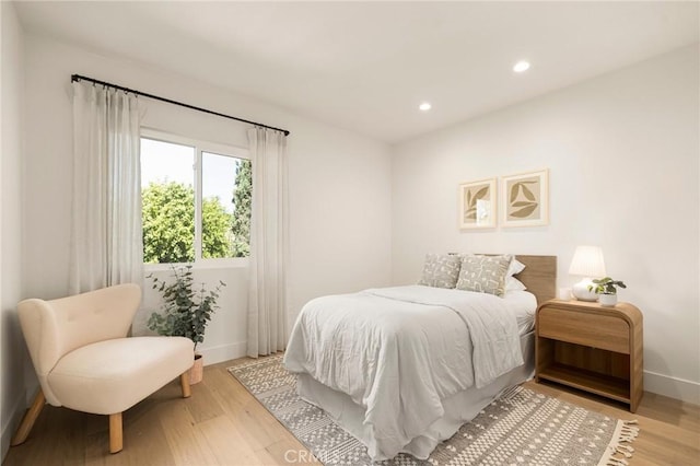 bedroom with light wood-style flooring, baseboards, and recessed lighting