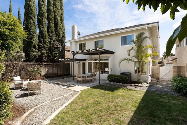 back of property featuring fence, a gate, stucco siding, a pergola, and a patio area