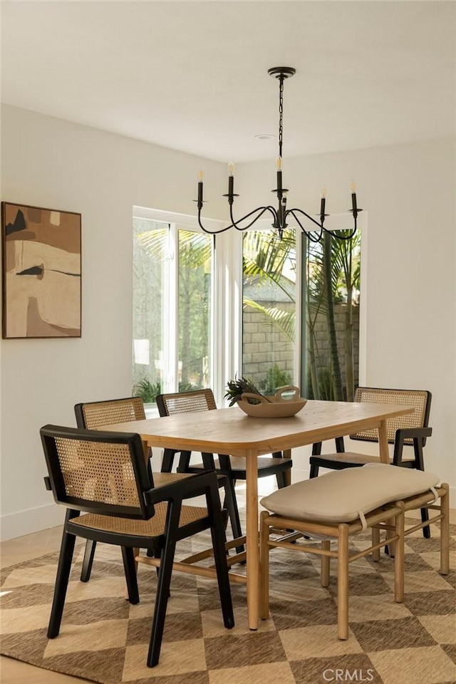 dining space with baseboards and an inviting chandelier