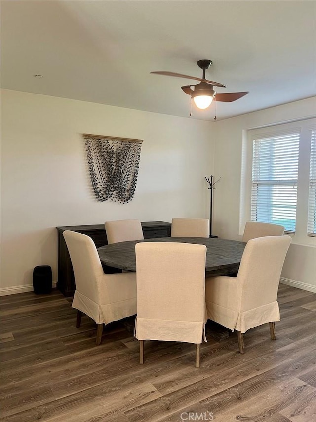 dining room with ceiling fan, wood finished floors, and baseboards