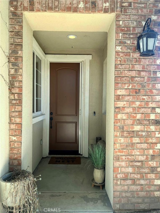 property entrance with brick siding