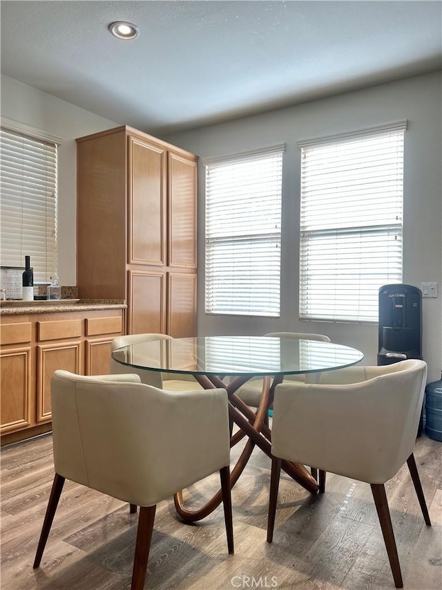 dining room with a wealth of natural light, light wood-style flooring, and recessed lighting