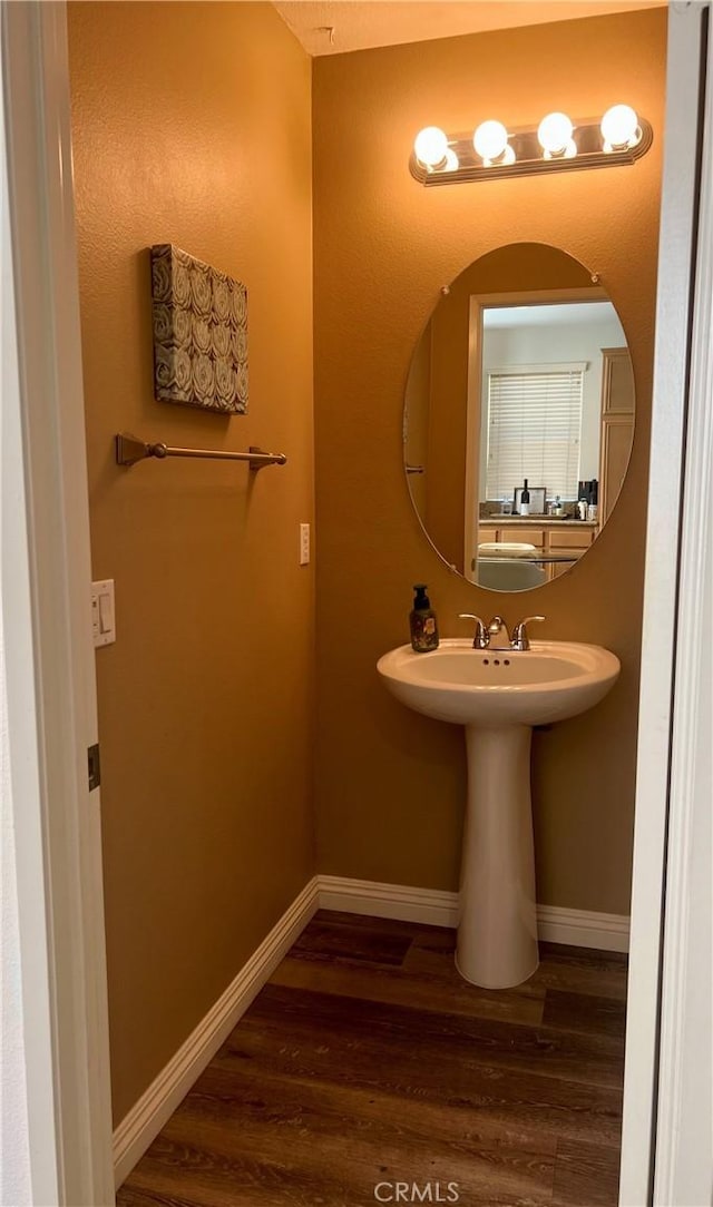 bathroom featuring baseboards and wood finished floors