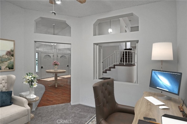 carpeted office featuring a towering ceiling