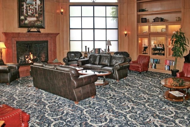 living room with carpet floors and a warm lit fireplace