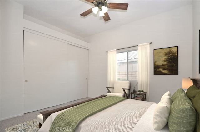 carpeted bedroom featuring a closet and ceiling fan