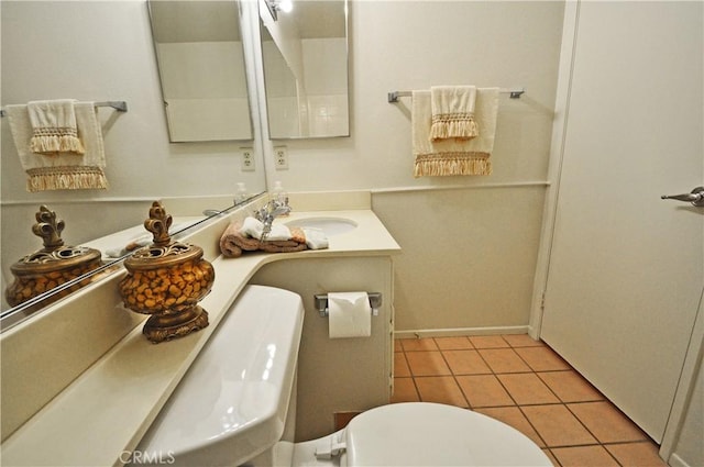 bathroom featuring vanity, tile patterned floors, and toilet