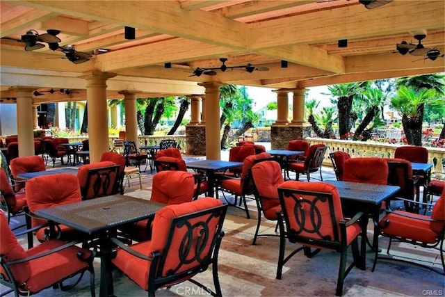 view of patio / terrace with a gazebo, outdoor dining space, and a ceiling fan