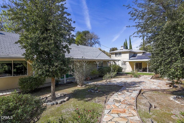 rear view of property featuring stucco siding