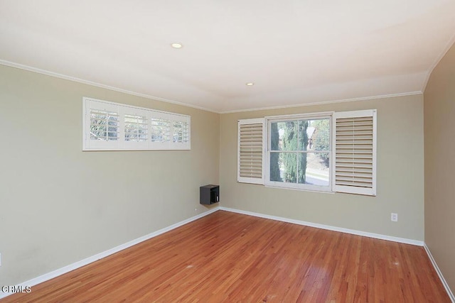 empty room with recessed lighting, baseboards, crown molding, and wood finished floors