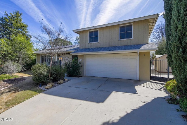 view of front of property with an attached garage, concrete driveway, and roof with shingles